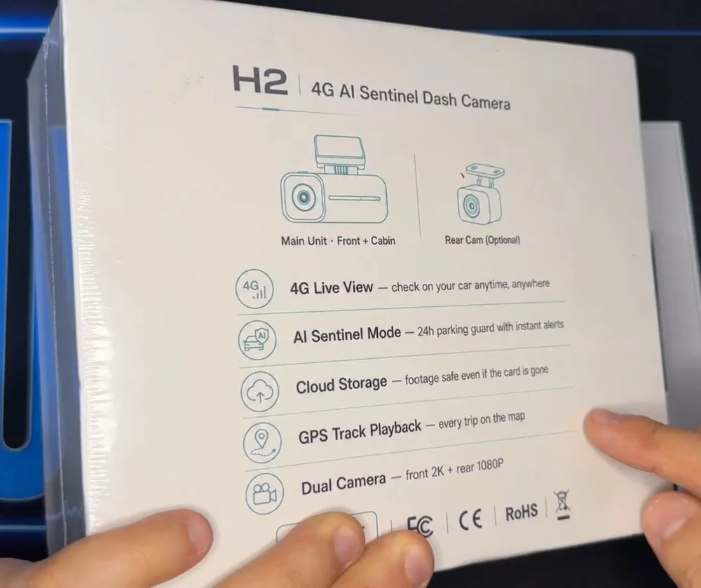 The H2 retail box, still shrink-wrapped, held in a hand